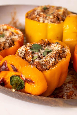 Grass-fed ground beef stuffed peppers in a serving bowl.