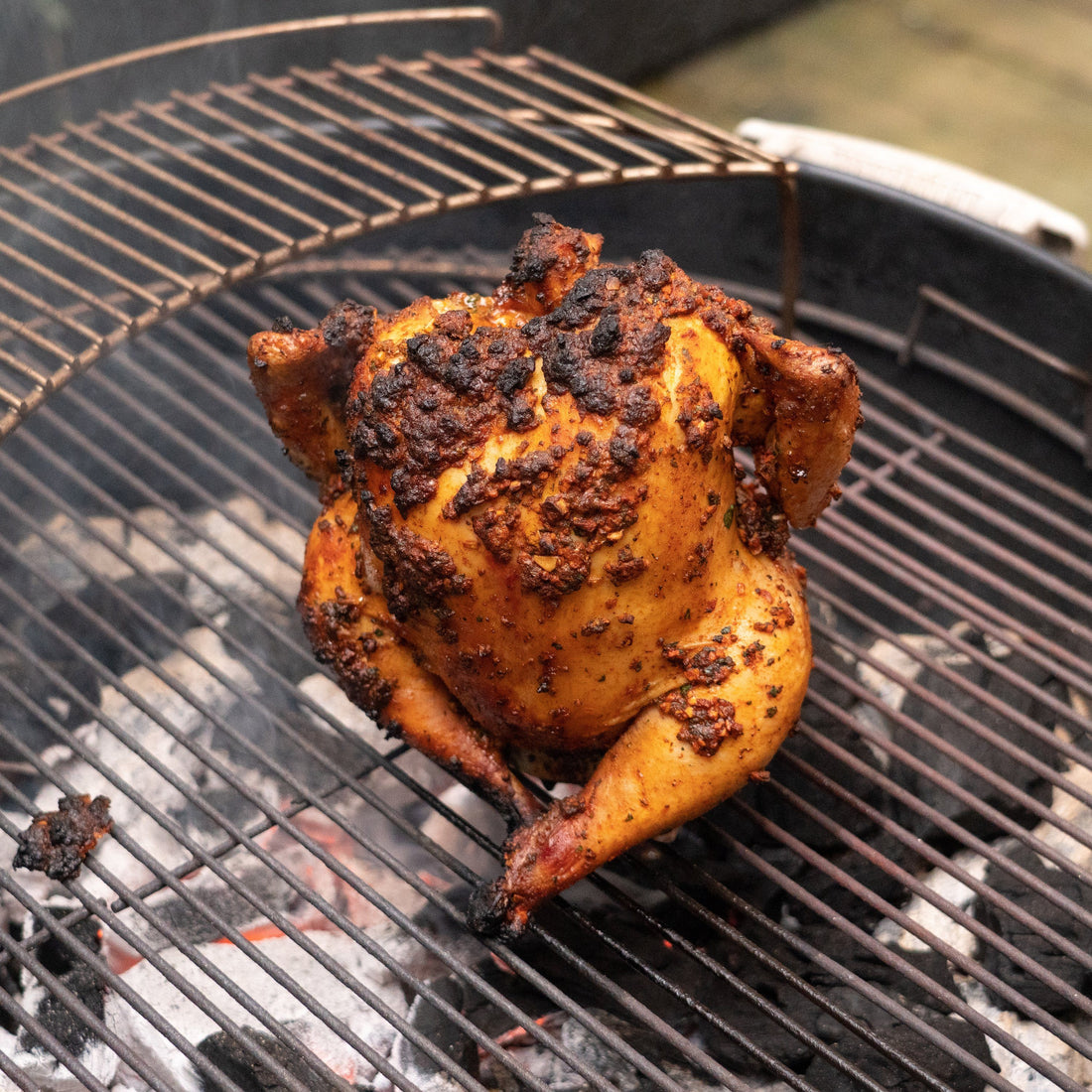 Cooked beer roasted chicken on a Weber Grill.