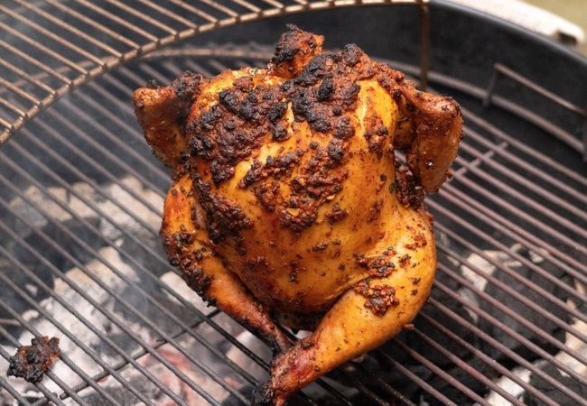 Cooked beer roasted chicken on a Weber Grill.